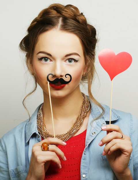 Girl wearing fake mustaches. 