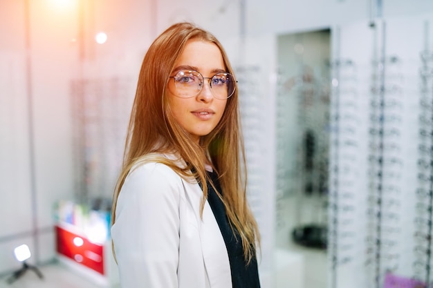 Girl wearing glasses Portrait of a woman in corrective glasses Eyeglasses in optics Presenting glasses