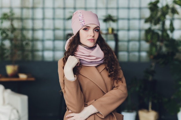 Girl wearing knitted warm hat, coat and scarf