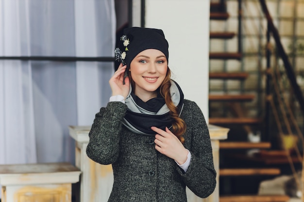 Girl wearing knitted warm hat, coat and scarf