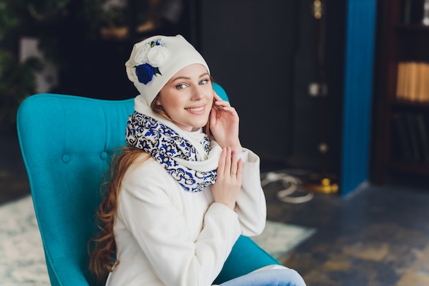 Girl wearing knitted warm hat, coat and scarf