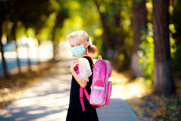 Girl wearing mask and backpack