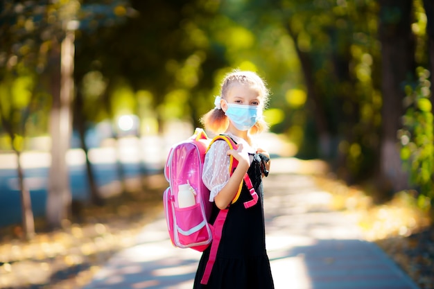 Girl wearing mask and backpack