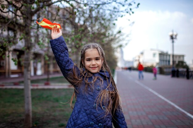 Girl wearing off the respirator medical mask in national Spain colors