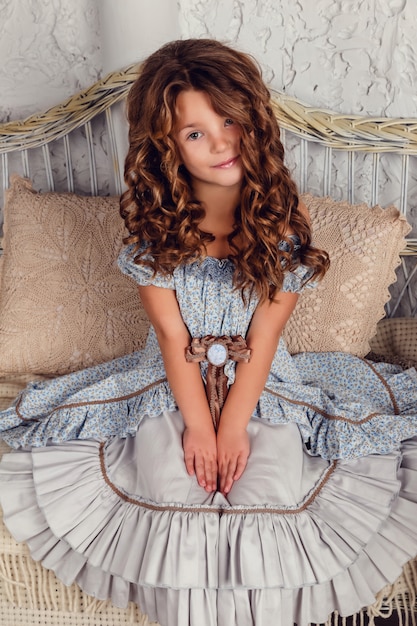 Girl wearing stylish retro dress posing over white background