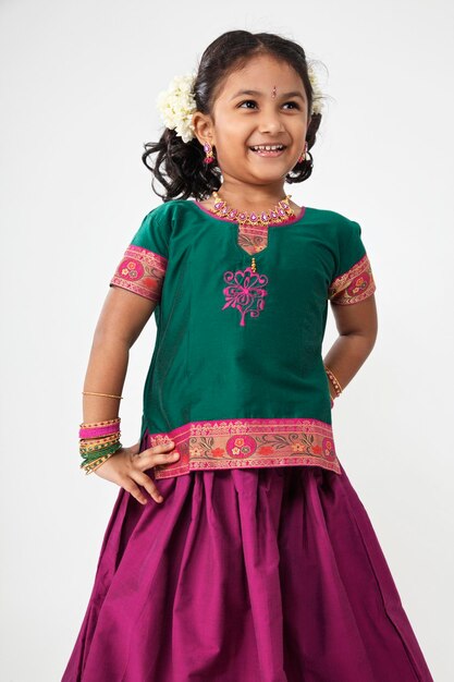 Photo girl wearing traditional clothes standing against white background