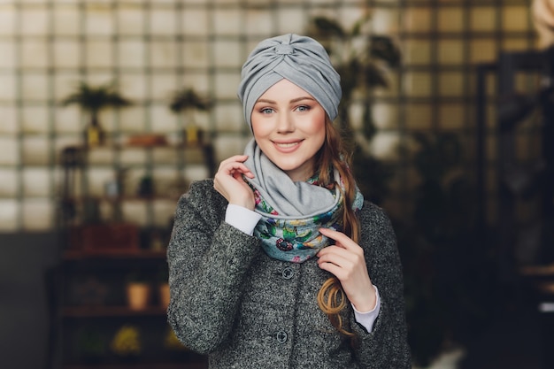 Girl wearing a turban, coat and scarf