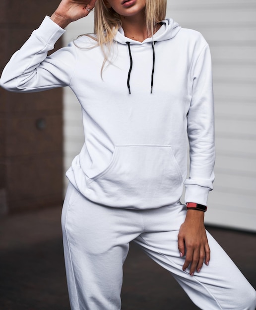 For Girl wears white hoodie and pants Blonde woman in loose tracksuit with no logo