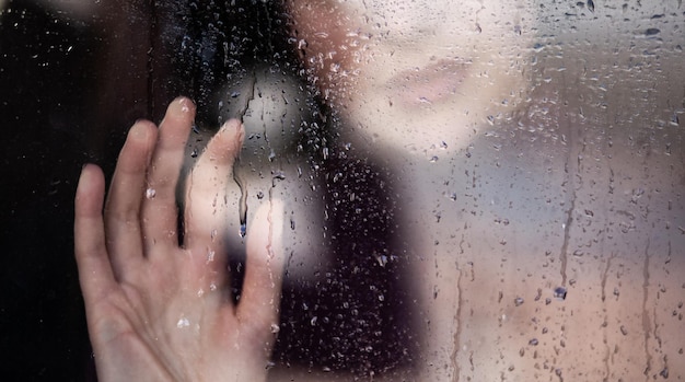 Girl at the wet window