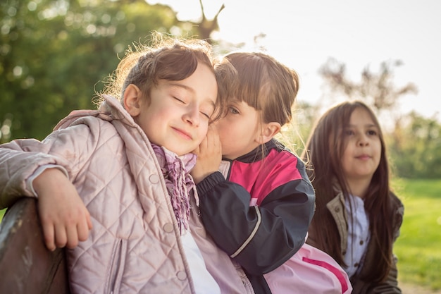 Girl whispering to her friend