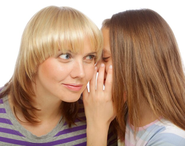 Girl whispering secrets in her mommy's ear