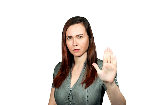 Photo the girl on a white background has exposed a palm before itself in gesture stop it