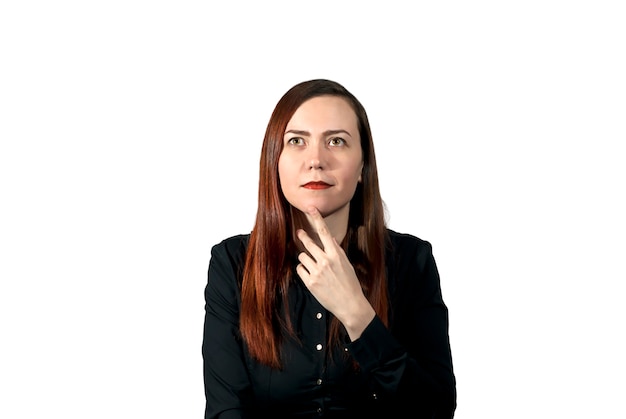 Girl on a white background looking thoughtfully upwards