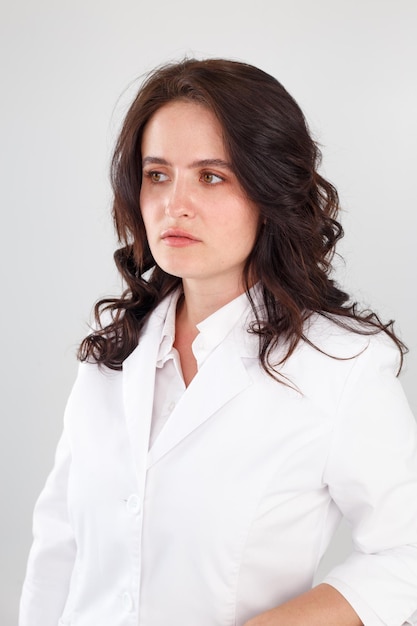 Girl in a white coat on a white background