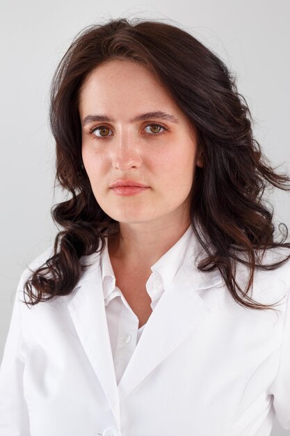 Girl in a white coat on a white background