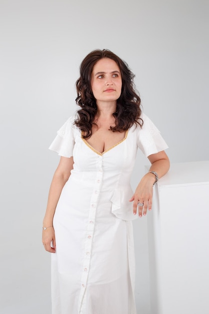 Girl in a white dress on a white background