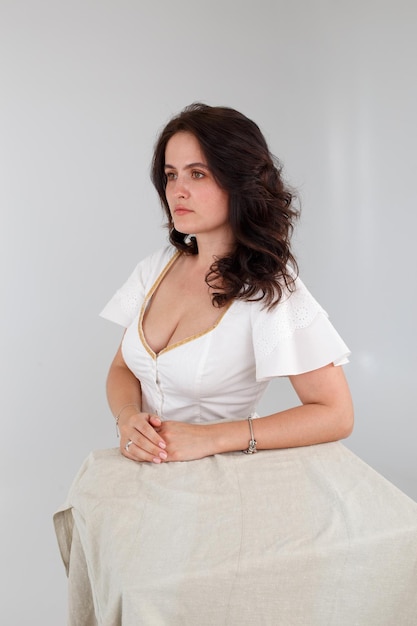 Girl in a white dress on a white background