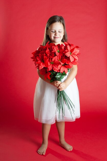 girl in white dress with a bouquet of mistletoe