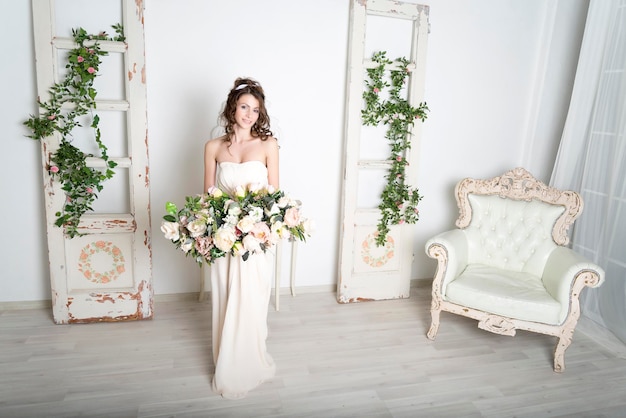 Girl in a white dress with flowers in the house