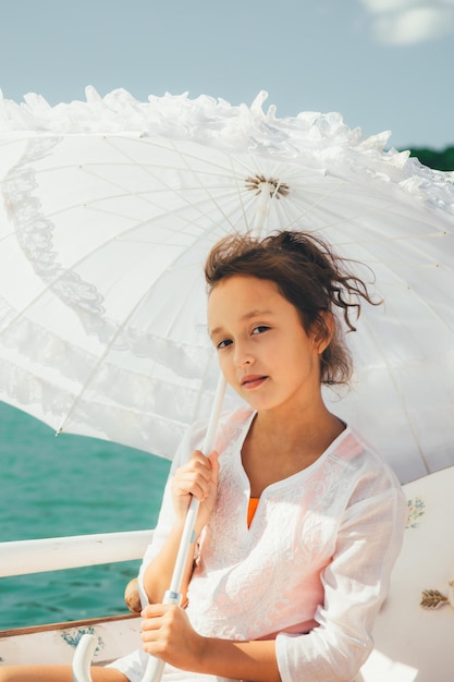 Girl under a white lace umbrella