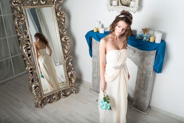 Girl in white near the mirror and the fireplace