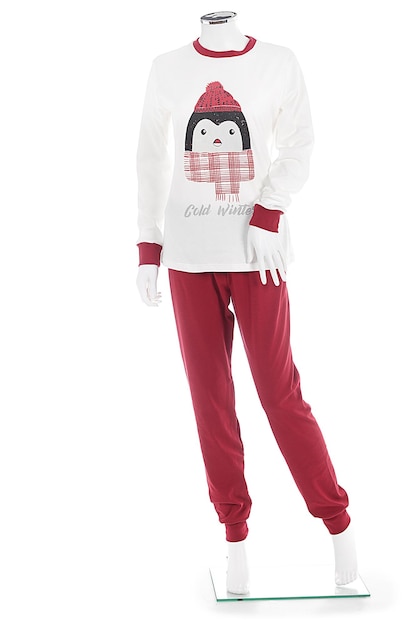 A girl in a white outfit with a red and black scarf that says crab and christmas on it.