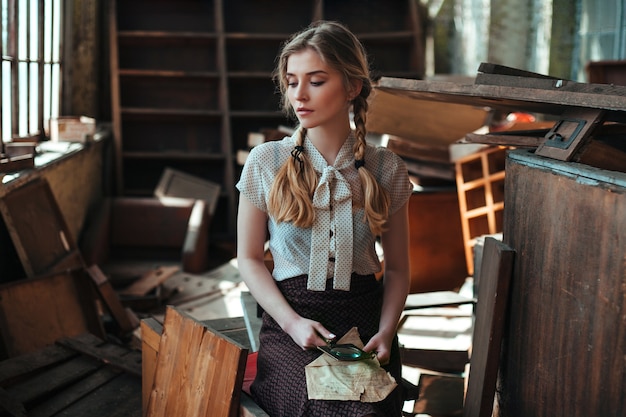 Photo girl in a white retro blouse in a ruined house