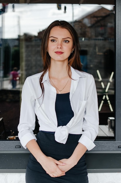 girl in a white shirt posing for the camera