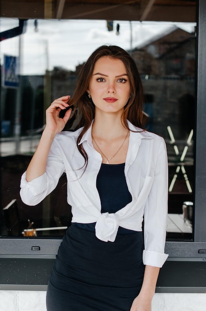 girl in a white shirt posing for the camera