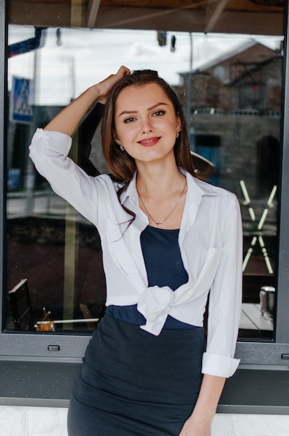 girl in a white shirt posing for the camera