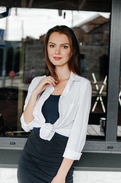 girl in a white shirt posing for the camera