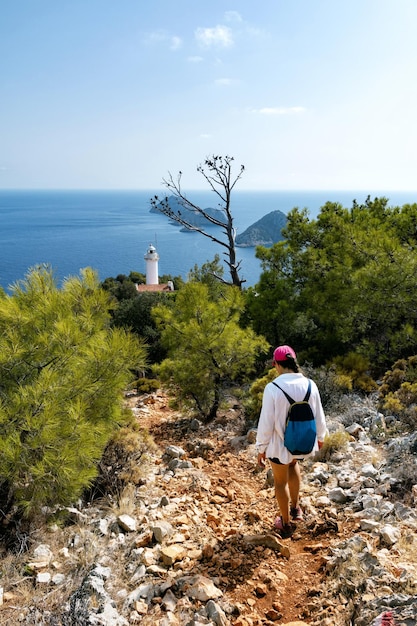 A girl in a white shirt walks along the Lycian Trail to the lighthouse View from Gelidonya Lighthouse Lycian Way Antalya Turkey