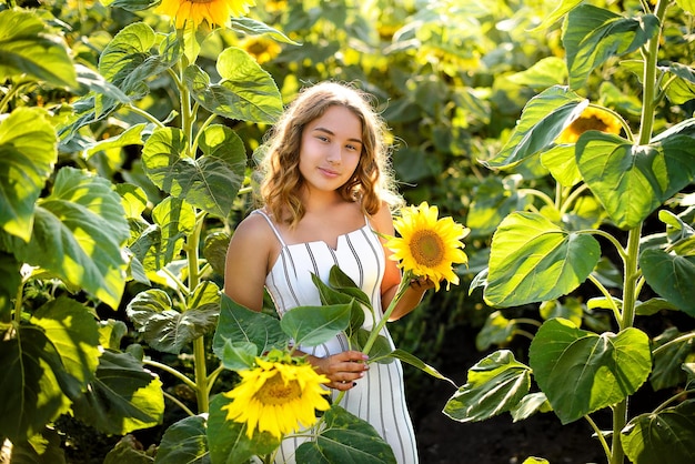 A girl in white in sunflowers Summer time