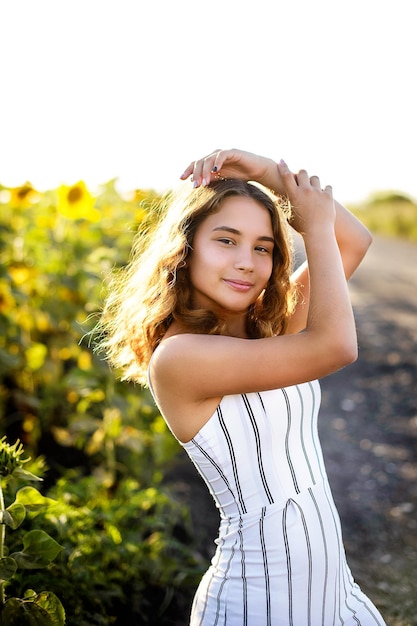 A girl in white in sunflowers Summer time