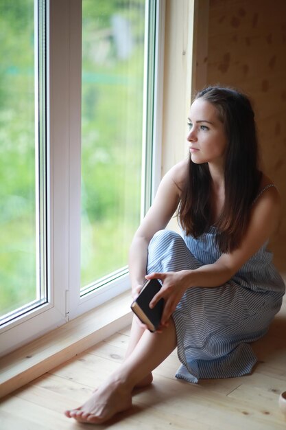 A girl at the window in the house