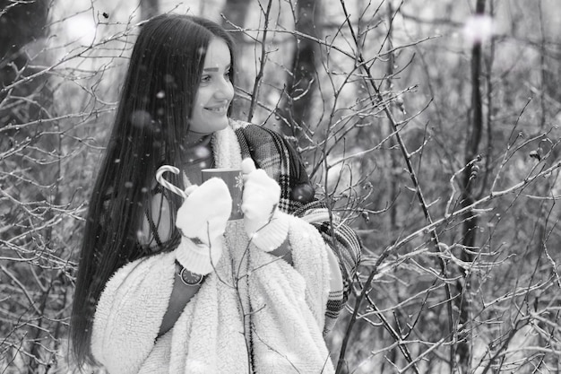 A girl in a winter cloudy day of snow-covered fields and forests