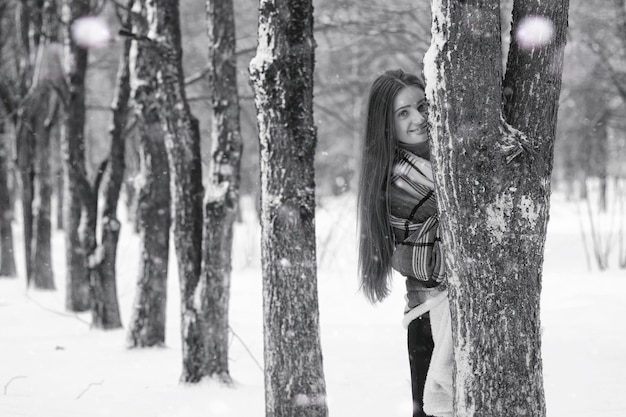 A girl in a winter cloudy day of snow-covered fields and forests