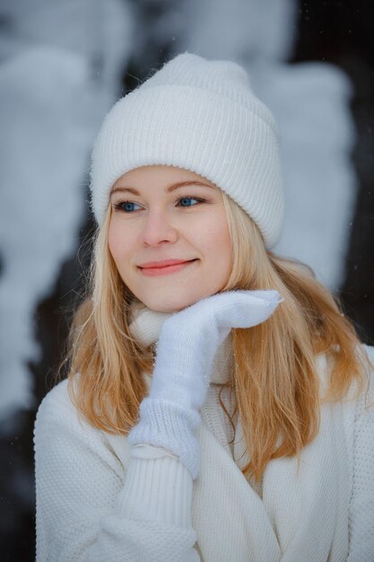 A girl in a winter forest, blonde, a fun walk in nature