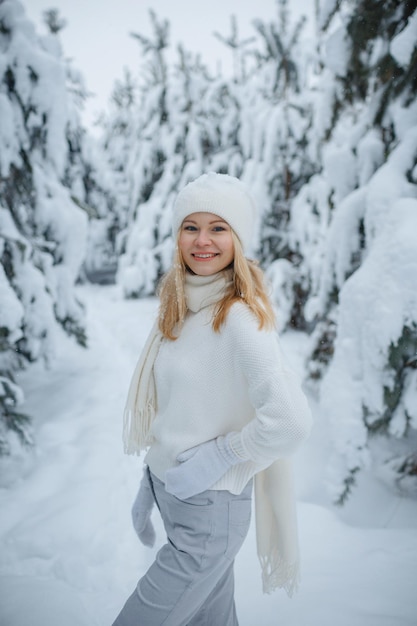 A girl in a winter forest, blonde, a fun walk in nature