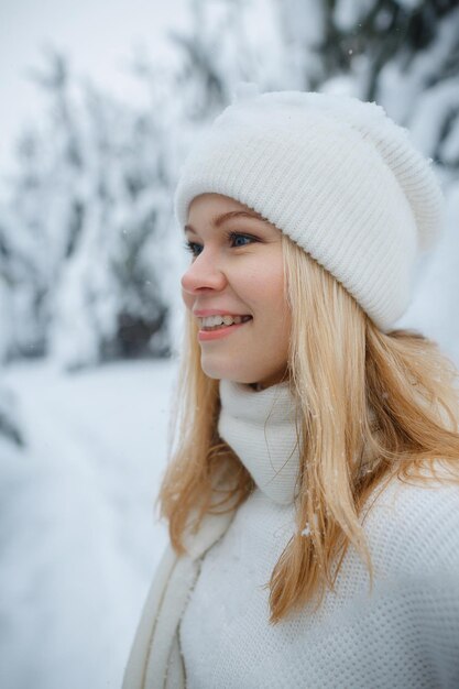 A girl in a winter forest, blonde, a fun walk in nature