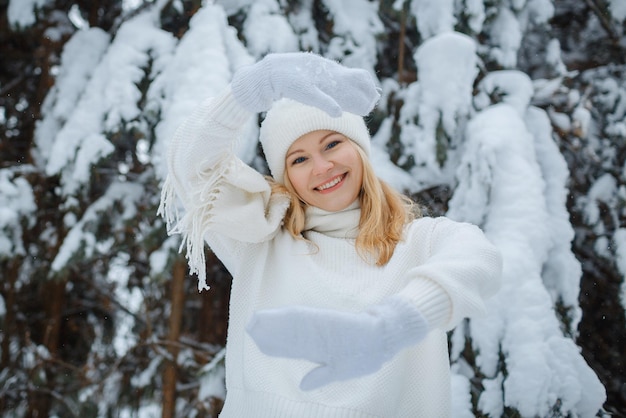 A girl in a winter forest, blonde, a fun walk in nature