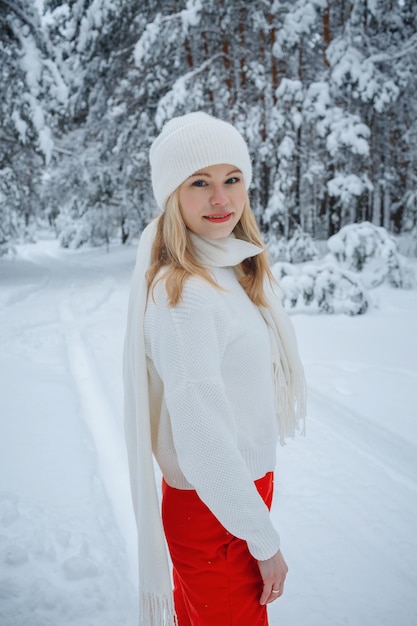 A girl in a winter forest, blonde, a fun walk in nature