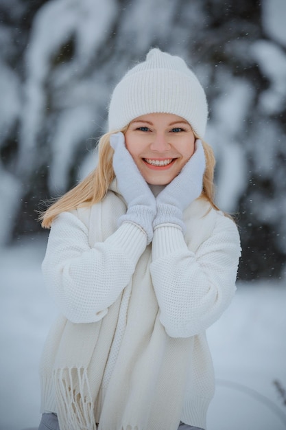 A girl in a winter forest, blonde, a fun walk in nature