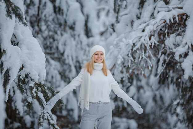 A girl in a winter forest, blonde, a fun walk in nature