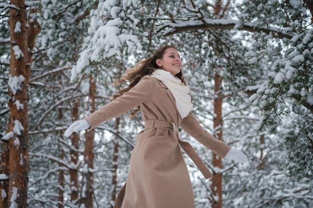 girl in winter forest with white trees and abundant snow