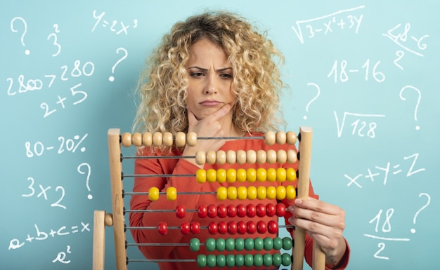 Photo girl with abacus is confused about the sum  cyan surface