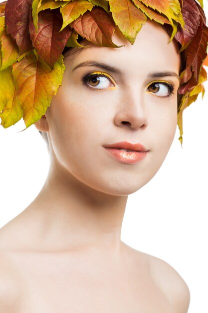 Girl with autumn leaves on the head