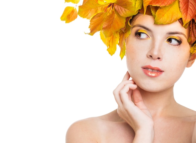 Girl with autumn leaves on the head