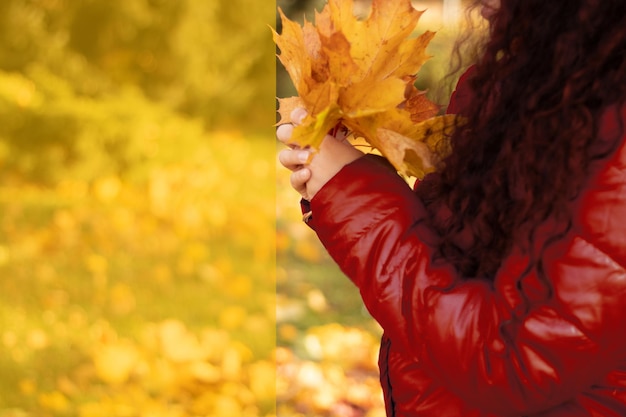 Girl with autumn leaves in her hands