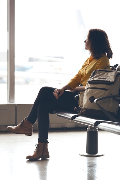 Girl with backpack waiting for departure